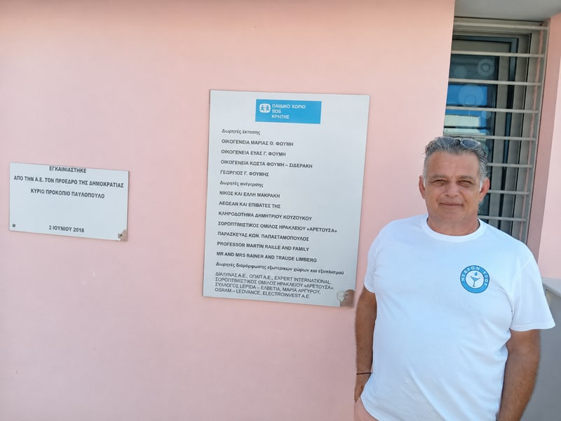 A technician at the SOS Children’s Village in Crete, beside the village donor board