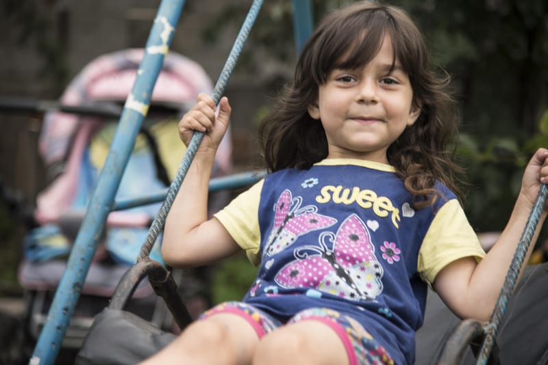 A child on a swing at an SOS Children’s Village in Greece